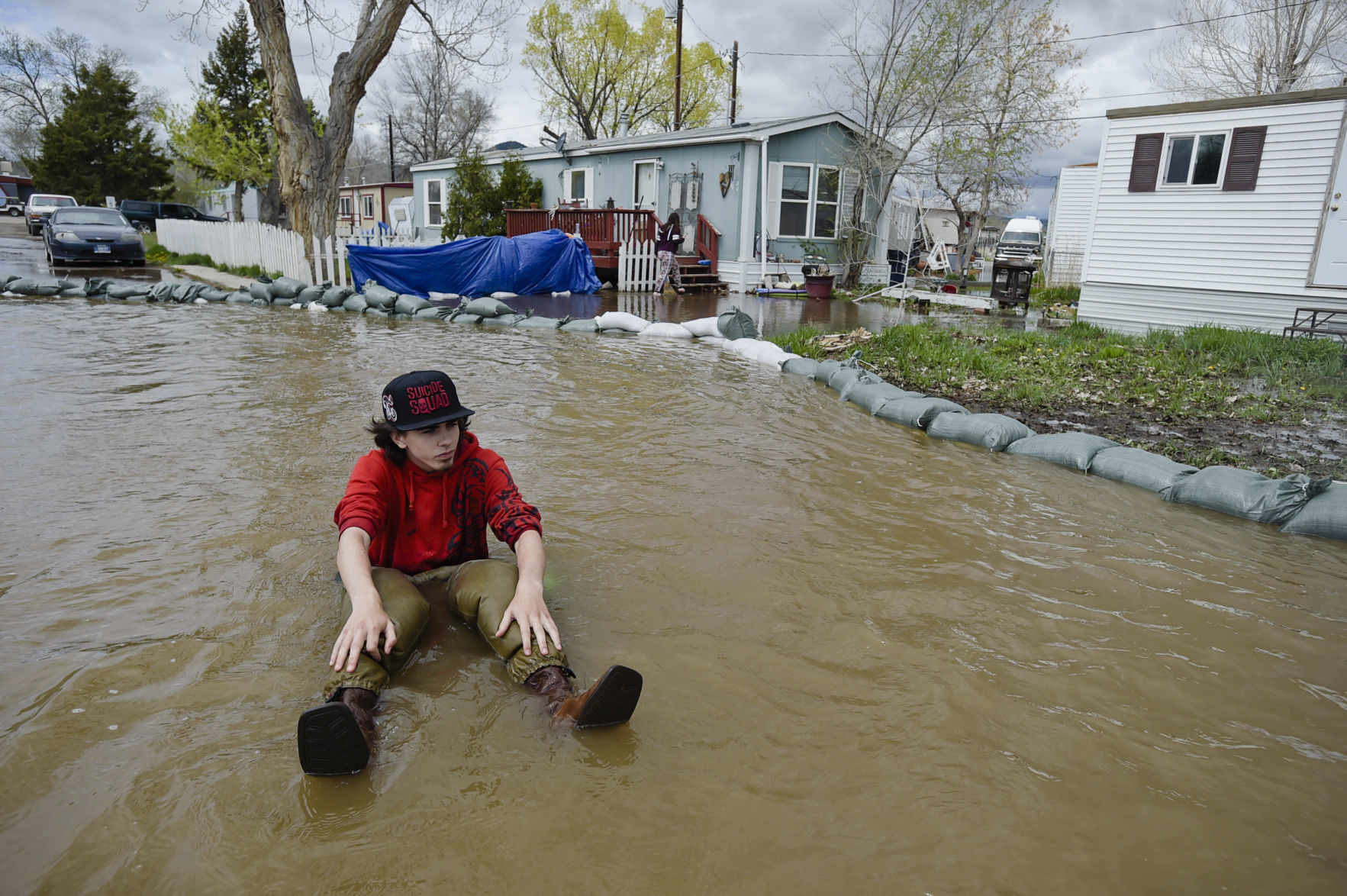 Maxx DaSilva floats on an inner tube down his street Monday in the Helena Campground and RV Park.